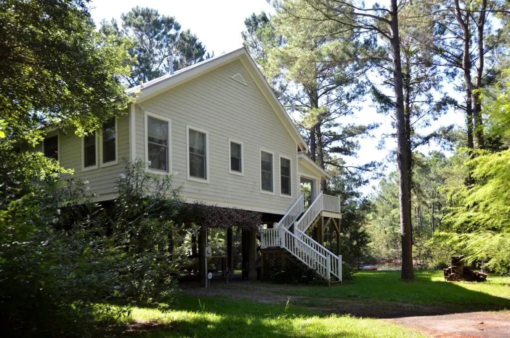 a house with a staircase and trees