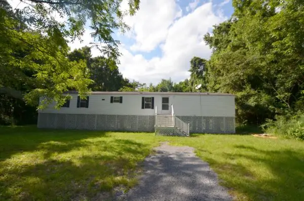 a house with a walkway and grass