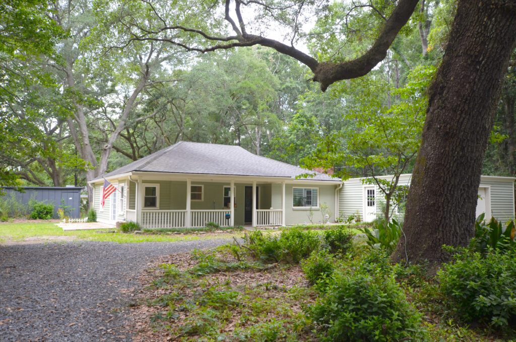 a house with a driveway and trees